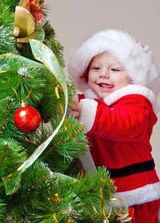 diy baby christmas photos - little santa decorating christmas tree