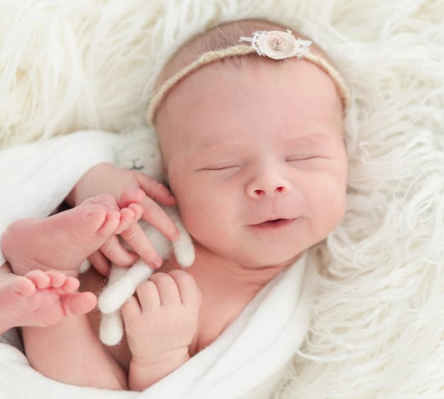 Premium Photo | Newborn baby sleeping with a small toy