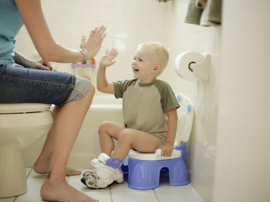 High-five after pooping in the potty is an effective stimulus for keeping the good work!- When to Start Potty Training | Baby Journey