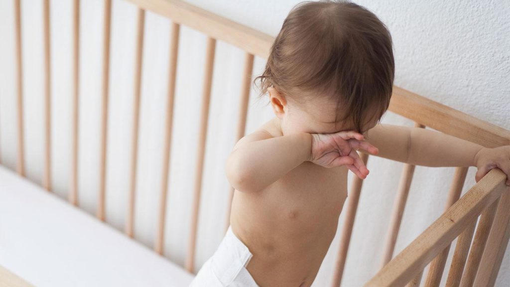 If your kid bangs the head against crib rails before sleep, you should put soft cushions on rails to prevent self harm - Is Baby Hitting Head with Hand A Normal Thing - Baby Journey blog