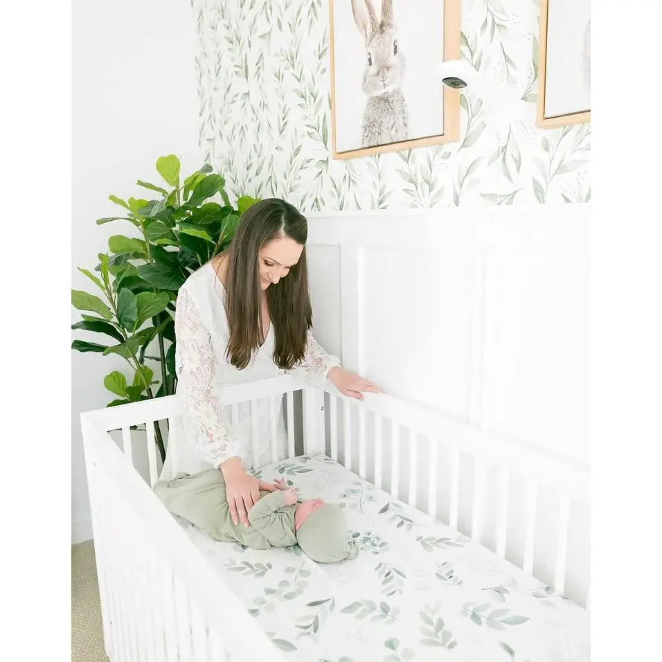 Mother watching baby sleeping in dadada Soho 3-in-1 convertible crib made from solid beech wood baby safe material - dadada Soho review - Baby Journey bl