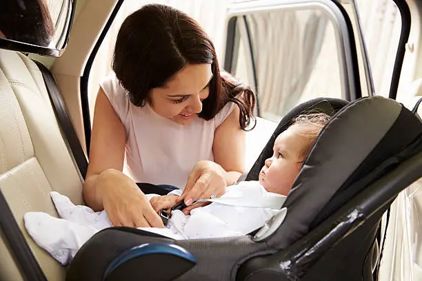 Mother Putting Baby Son Into Car Travel Seat | Best All-in-One Car Seat | Baby Journey