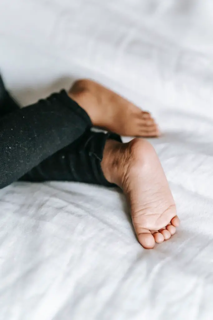 A toddler's feet on the bed. - Toddler won't stay in bed at bedtime - Baby Journey blog