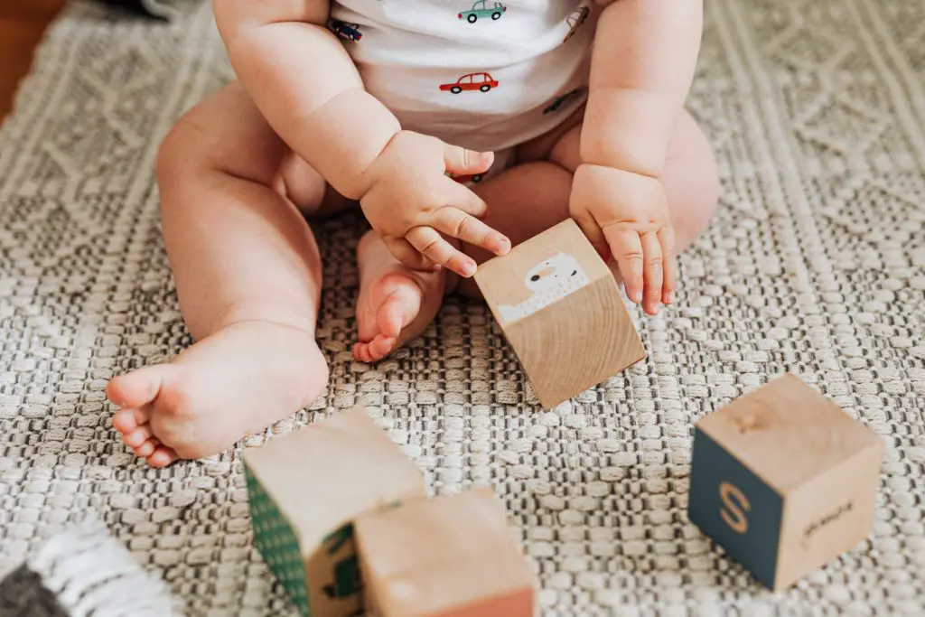 Baby playing with building blocks toys for kids - Buy kids toys online shopping - Baby Journey blog