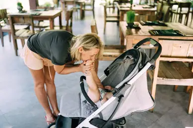 Mother kissing baby's feet in special needs stroller - Best Special Needs Stroller - Baby Journey