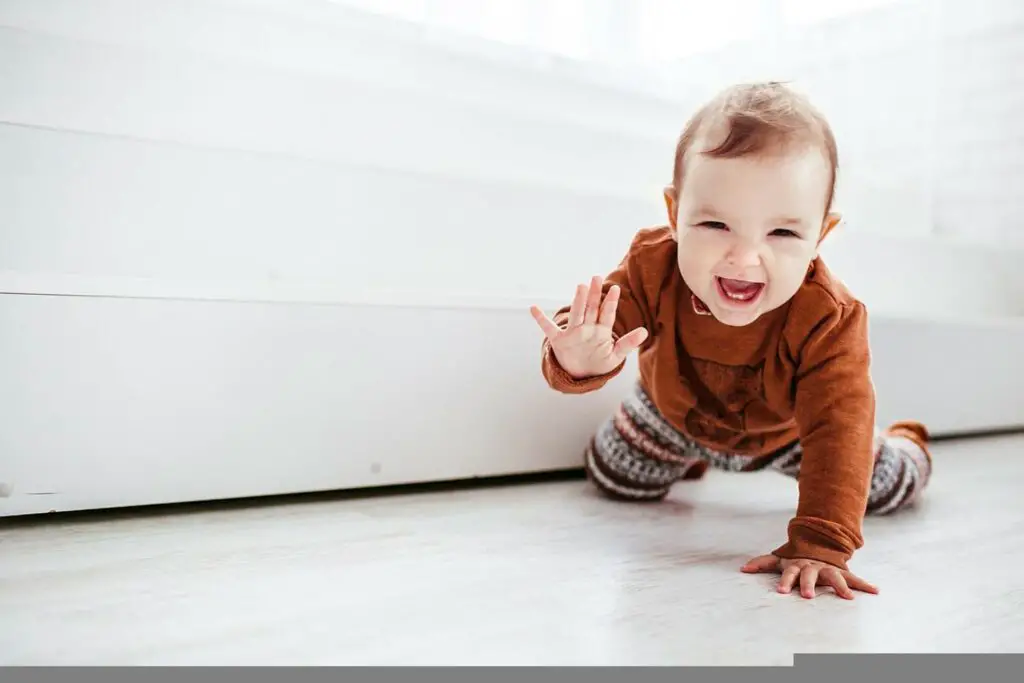 A happy crawling infant - Benefits of crawling for babies - Baby Journey