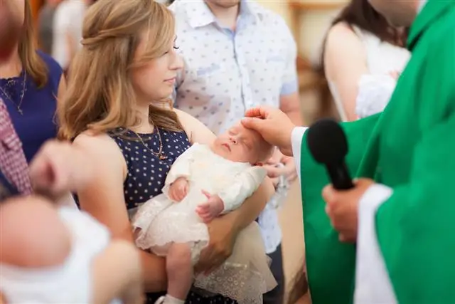 A baby being dedicated at church - Baby dedication vs baptism - Baby Journey