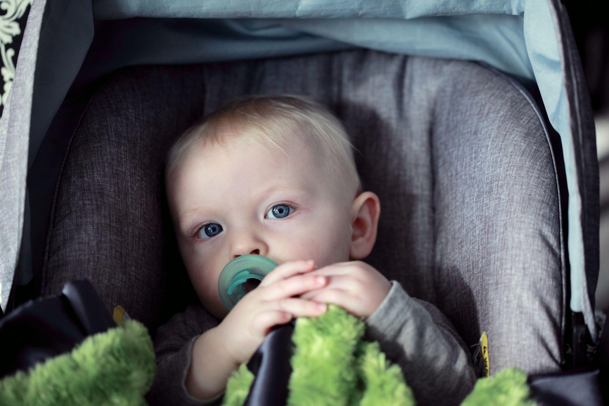 Baby sucking on pacifier while in his car seat - Can you feed baby in car seat - Baby Journey