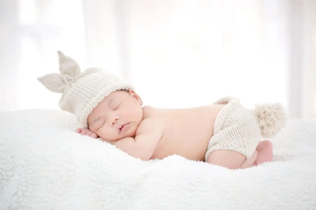 Cute baby with knitted hat - Why Do Babies In Denmark Sleep Outside - Baby Journey 