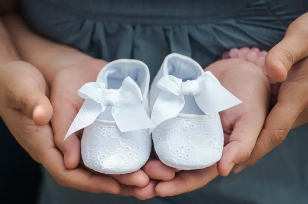  Parents holding the baby’s shoe - Places to Have a Baby Shower - Baby Journey