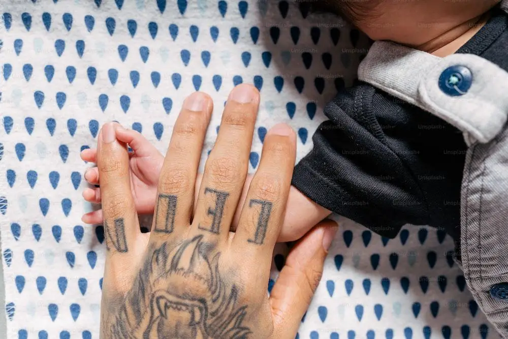 a person with a tiger tattoo on their hand