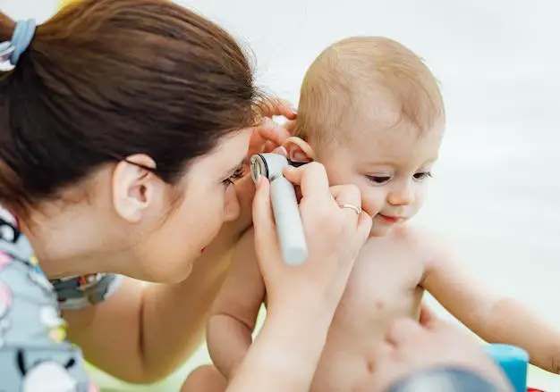 Doctor is checking baby’s ear - Why Does My Baby Grab His Ears - Baby Journey