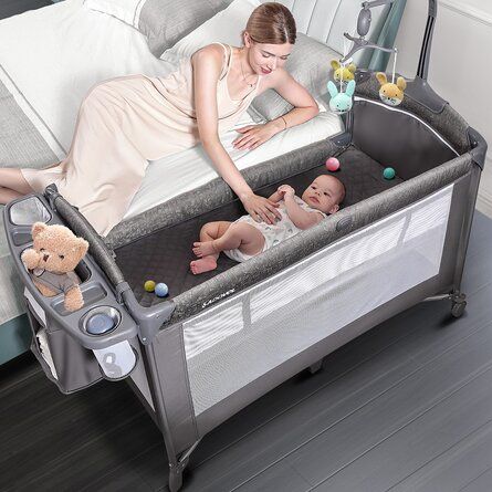 Baby in the pack n play- Should You Get A Crib Vs Pack And Play For Baby - Baby Journey