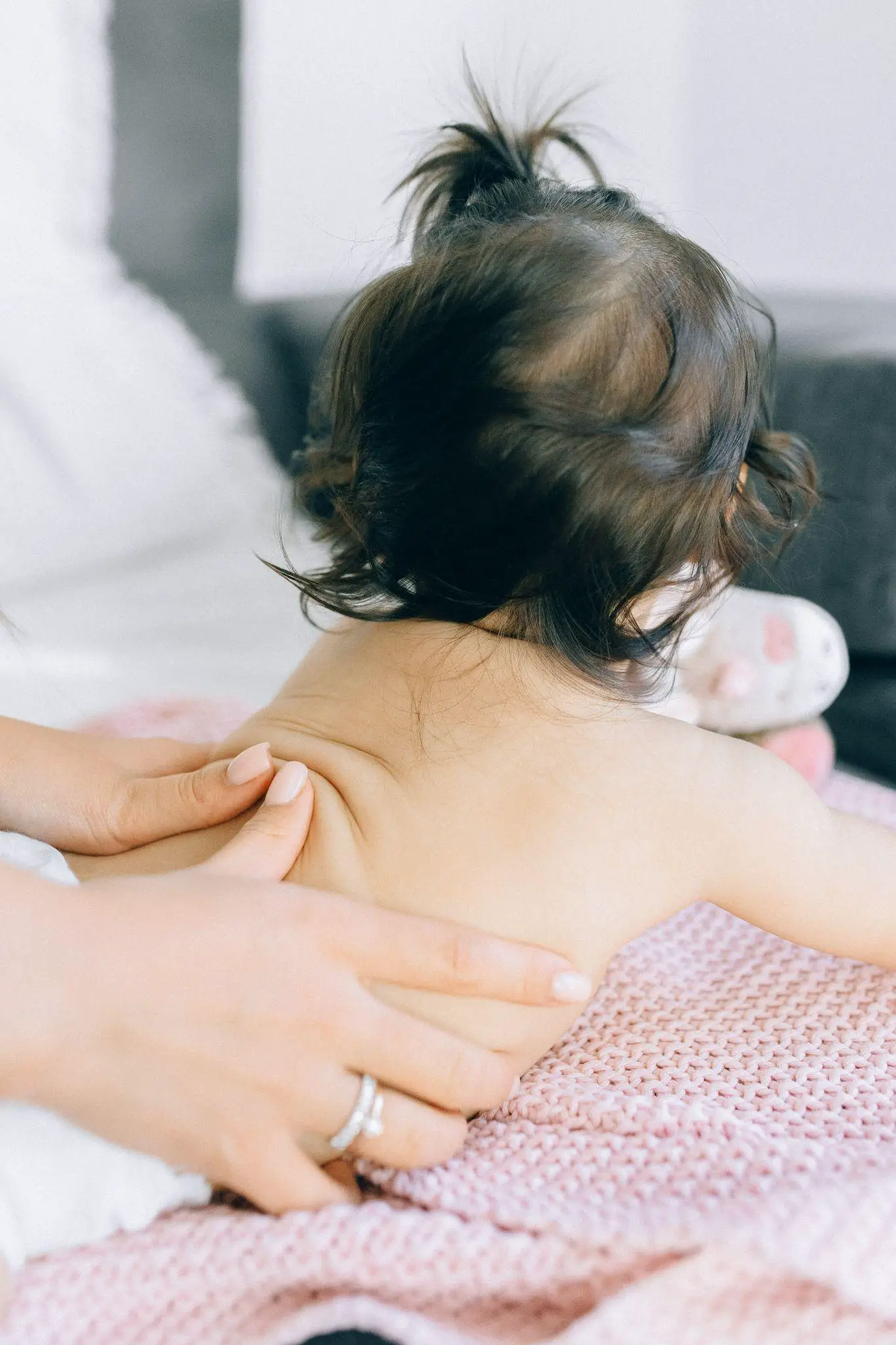 Parents are massaging their babies - Why Does My Baby Arch His Back - Baby Journey