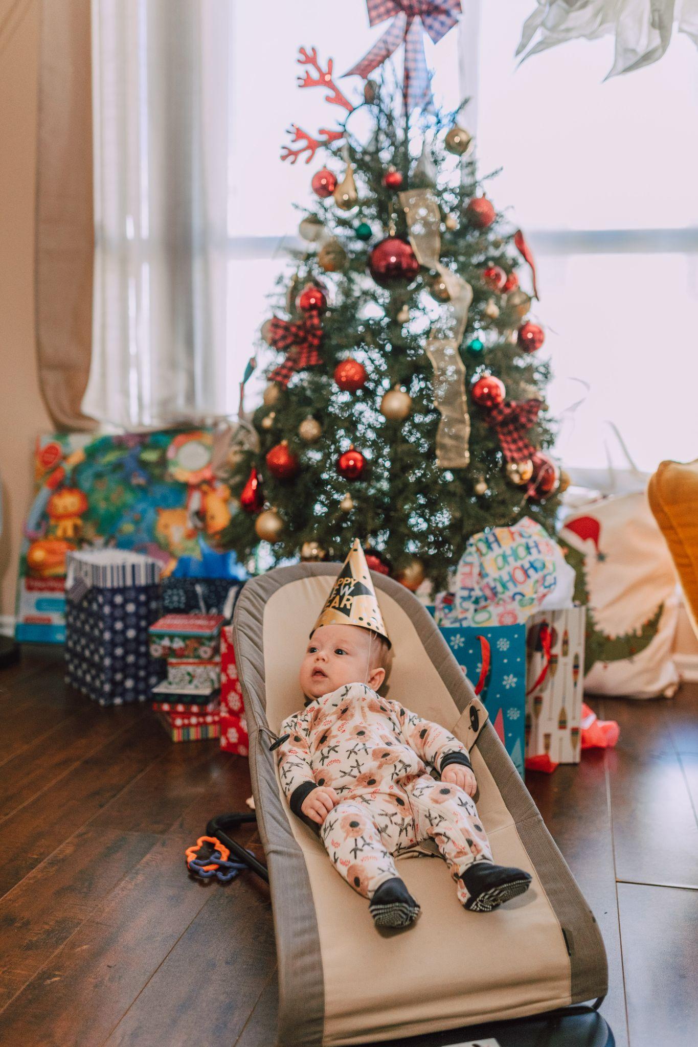 Baby boy wearing a holiday-themed onesie to celebrate Christmas - Funny Baby Onesies - Baby Journey