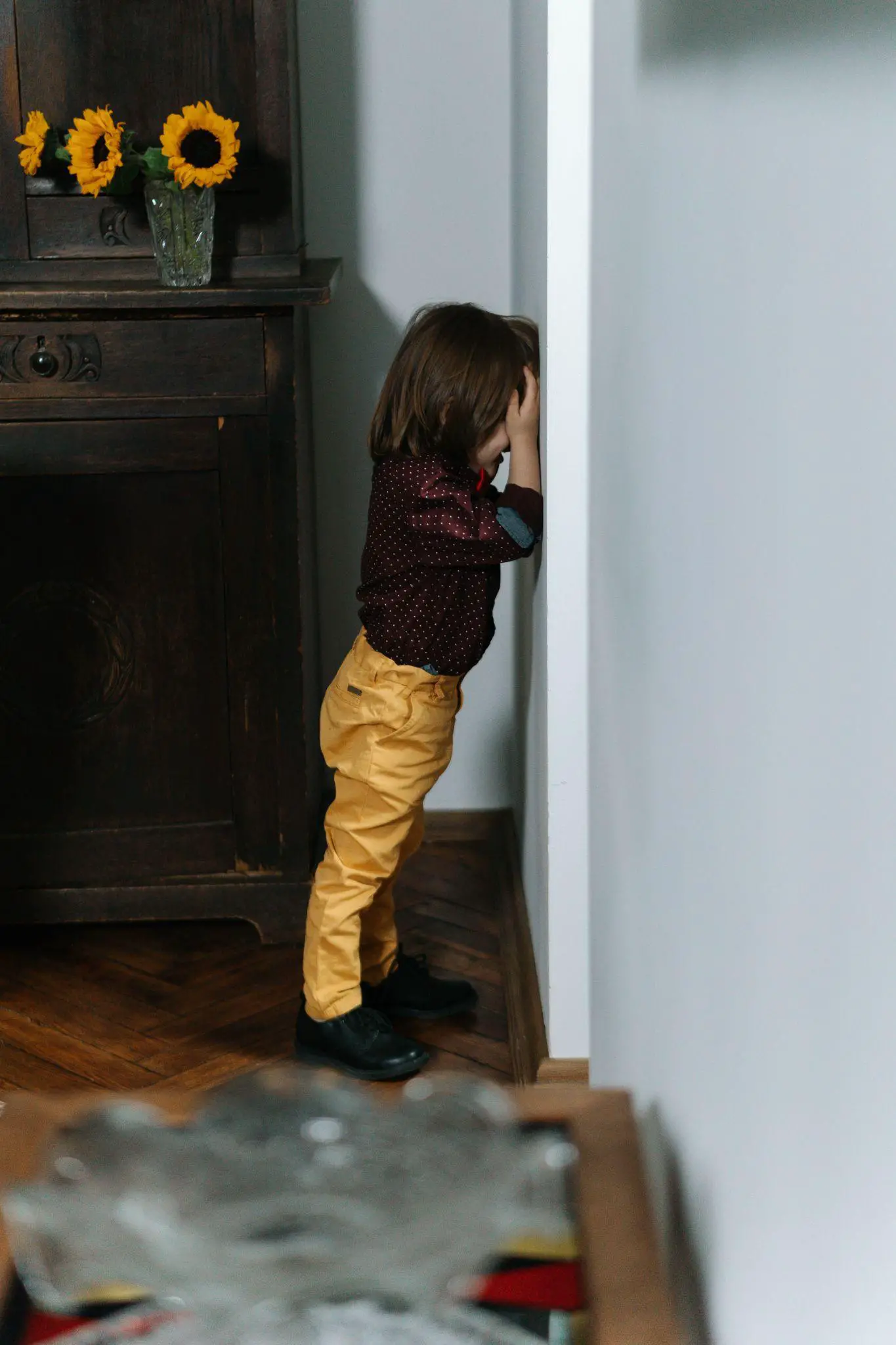 The kid is crying against the wall - How to Spank Your Child Effectively - Baby Journey