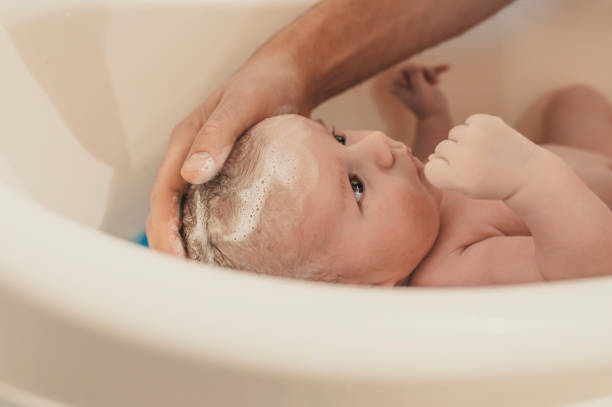 Parents washing baby's hair - How to Wash Newborn Hair - Baby Journey
