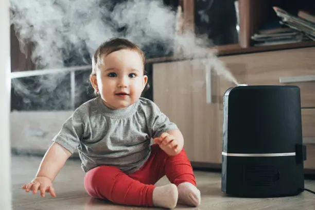 Baby next to the humidifier - How Close Should a Humidifier Be to a Baby - Baby Journey