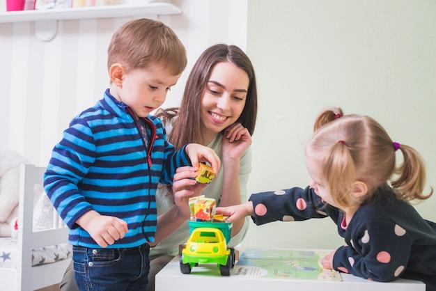 Mother is Teaching Her Children Sharing Their Toys - Why Sharing is Important - Baby Journey  
