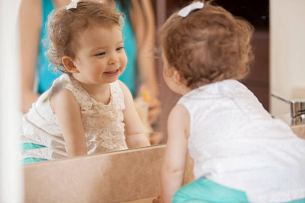 Baby smiles at herself in the mirror - When Do Babies Recognize Themselves in the Mirror - Baby Journey 
