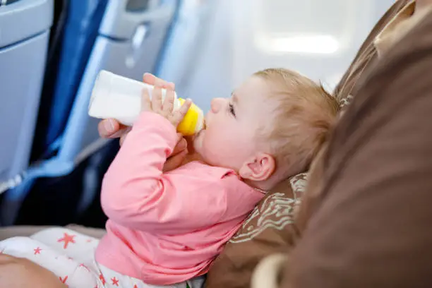 The baby is drinking milk - How to Travel with Formula - Baby Journey