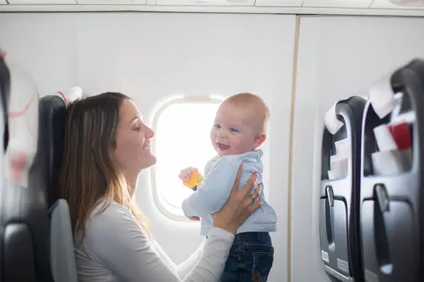 Mom and baby on an airplane - How to Travel with Formula - Baby Journey