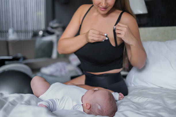 Mothers wear nursing bras back after breastfeeding - How Many Nursing Bras Do I Need - Baby Journey