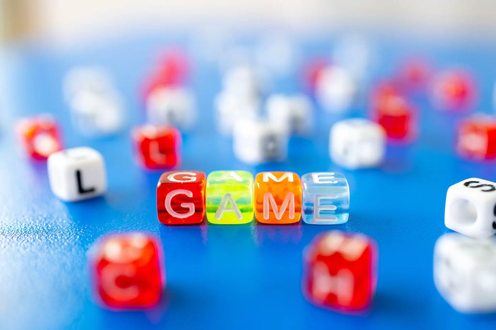 Photo of colorful alphabet beads showing the word GAME - 7 Amazing Word Games for Kids - Baby Journey