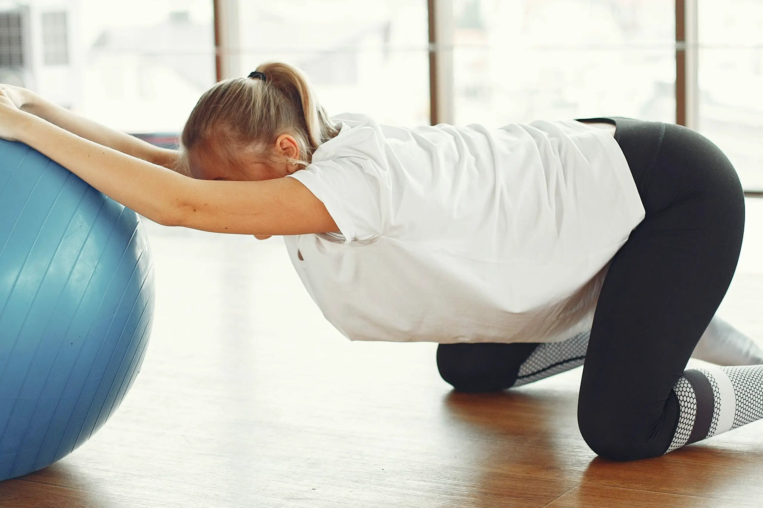 A woman exercising indoor - Postpartum Exercise, Postpartum Workout, Postpartum Fitness - Baby Journey 