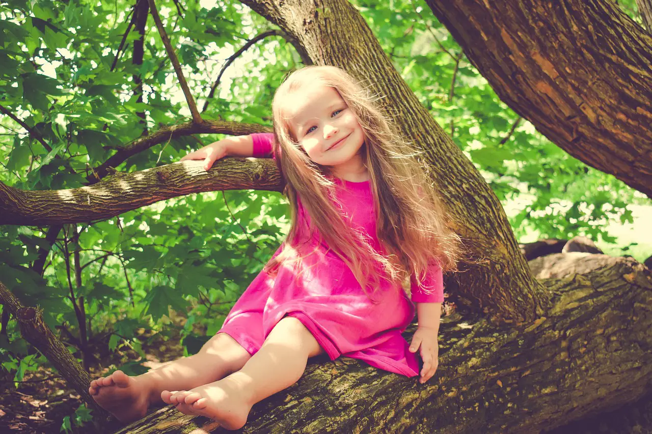 A lovely girl sitting on top of the tree branch - 320+ Goddess Names for Girls - Baby Journey