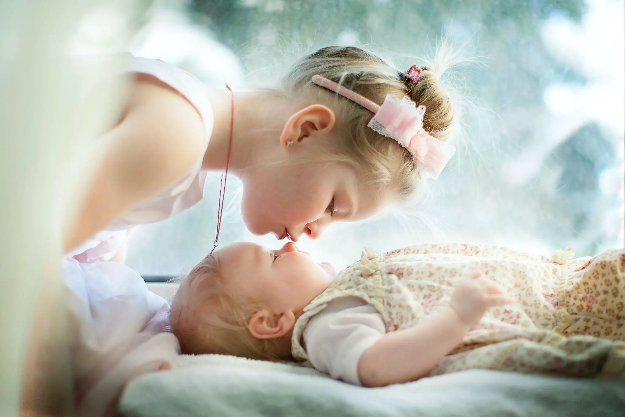 A lovely girl kissed her charming little sister - 100+ Best Nicknames for Elizabeth - Baby Journey
