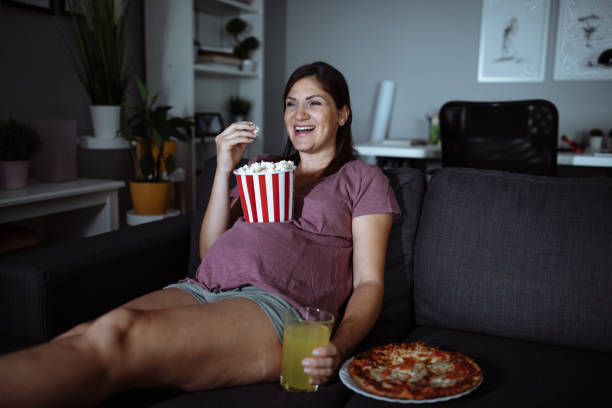 Pregnant lady watching tv - fun things to do while pregnant - Baby Journey parenting blogs